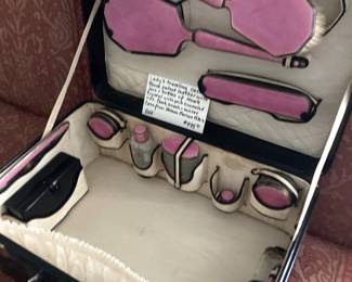 Lady's travel case with black patent leather with jars  and bottles of Hawk crystal with pink enameled lids and comb, brush, mirrors, (1920's - Neiman Marcus)