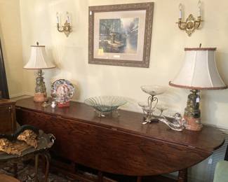 Oval drop-leaf dining table; matching lamps