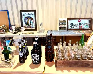 Assorted vintage growlers and soda bottles