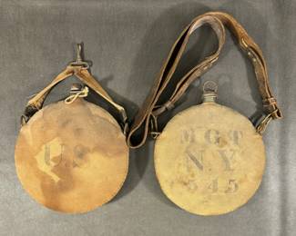 Authentic US Army issue model 1878 - 1885 canteens. One marked US with modified saddle strap, one marked MGT NY 545 with original leather strap. 