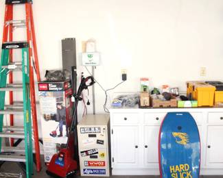 8' and 6' fiberglass ladders and garage full of a variety of tools and garden items.