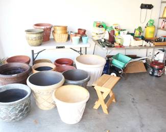 Variety of  planters and gardening items.