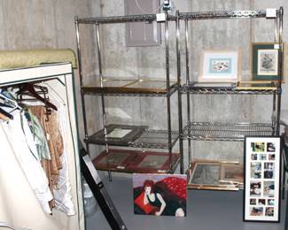  Four tier wire metal shelves with lots of wall art.