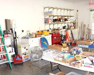 8' and 6' fiberglass ladders and garage full of a variety of tools and garden items.