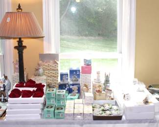 Table full of collectibles.  Precious Moments, Ashton Drake, The Bradford Exchange and Cherished Teddies.