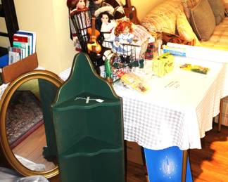 Hanging shelves, oval mirror and dolls.