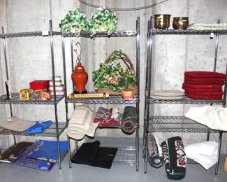Four tier wire metal shelves and misc. decor, rugs and chair cushions.