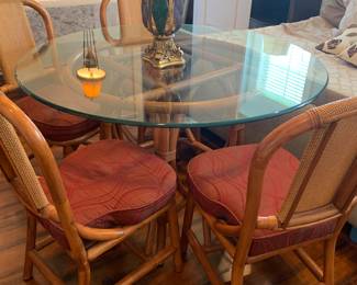 round glass top table with four chairs