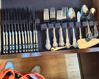 #168 - $80.00 - Flatware Set, 12 dinner knifes, 12 dinner forks, 10 desert forks, 12 teaspoons, 12 table spoons, 1 serving spoon, 1 serving fork, 1 cake cutter, 1 butter knife