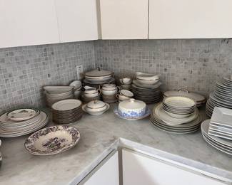 Gold and white china with serving pieces.