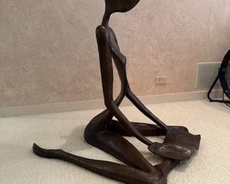 Bronze Figure reading a book, signed and numbered, by John Kennedy. Measures approx. 39"x39"x39" 
