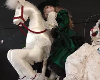 DOLL ON A CARNIVAL HORSE