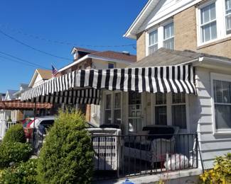 Black & white stripe awning; wrought iron railing