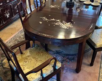 Beautiful imported dark cherry rosewood dining table (mother of pearl inlay) with 6 chairs and two leaves. Cushions are removable for complete wood chairs