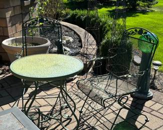 Two sets of patio tables and chairs