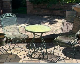 Two sets of patio tables and chairs