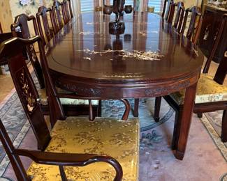 Beautiful imported dark cherry rosewood dining table (mother of pearl inlay) with 6 chairs and two leaves. Cushions are removable for complete wood chairs