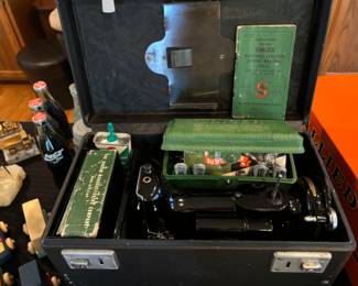 Small Singer sewing machine in pristine condition.