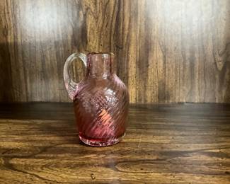 Small, cranberry art glass jug