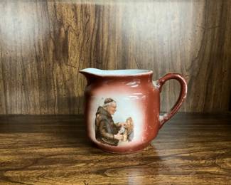 Vintage creamer with monk pouring a beer
