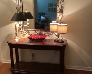 Hall table with lamps, decor and framed mirror