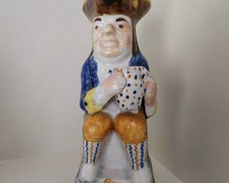 Prattware Toby jug, circa 1800, seated and holding frothing jug of beer, decorated in typical colours, with sponged base, back and handle