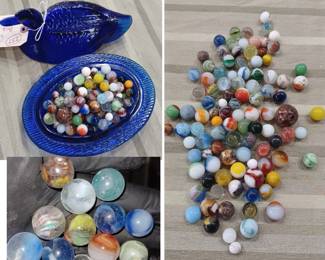 cobalt blue duck on nest full of old marbles, one is a German lattacino swirl