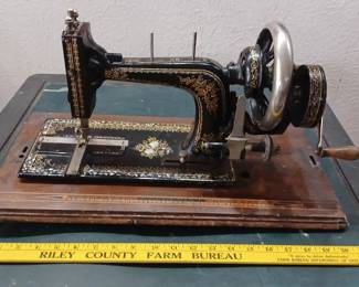 Antique German sewing machine with inlaid mother of pearl, hand crank. 