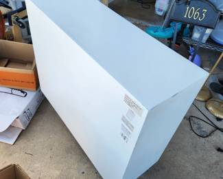 Back angle of the mirrored chest of drawers.