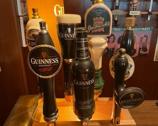 Multiple Guinness (and other) taps in lighted holder.