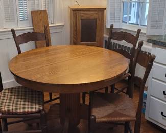 Oak table on casters with leaf, four rush seat chairs