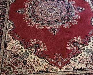 Persian rug in reds and black, in back bedroom