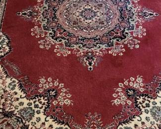 Persian rug in reds and black, in back bedroom