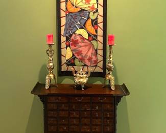 Antique Asian medicine cabinet with silk tapestry signed by Schorr and brass candlesticks