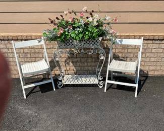 Two White Chairs And A Plant Stand
