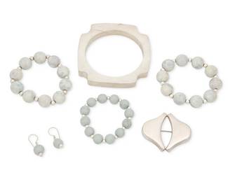 2066
A Group Of Silver And Stone Bead Jewelry Including Georg Jensen
Mid/late 20th century
Brooch marked for Georg Jensen; further stamped: 925 S / Denmark / 381 [design number]; Bangle stamped: Mexico / TR-28
Comprising a Georg Jensen Danish sterling silver modernist brooch, a chunky Mexican silver modernist bangle bracelet, three jadeite and silver bead stretch bracelets, and a pair of matching jadeite bead earrings, 7 pieces
Brooch: 1.5" H x 1.875" W; bangle: 7.75" inner C; each bracelet: 5.5 to 6" inner C (expandable); earrings: 1.25" H
Silver: 72.9 grams gross
Estimate: $200 - $400