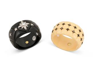 2124
Two Miriam Salat Resin And Sterling Bangles
21st century
Each marked: Mirim / 925
Two works including a cream resin bangle with a quilted texture, two rows of sterling silver stars and set faux diamonds, as well as a black resin quilted bangle with a central faux diamond floral motif banded by a row of stars, 2 pieces
Each: 7.75" inner C x 1.625" H
Estimate: $200 - $300