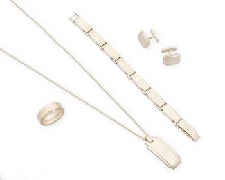 2005
A Set Of Tiffany & Co. Sterling Silver Jewelry
Late 20th/21st century
Each stamped: © / Tiffany & Co. / 925
A group of chunky silver panel and screw motif jewelry, including a pendant necklace, a link bracelet, a ring band, and a pair of cuff links, 6 pieces
Necklace: 24" L x 1.75" H; bracelet: 8" L x 0.375" H; ring: size 13; cuff links: 0.5" x 0.75"
135.1 grams
Estimate: $1,000 - $2,000