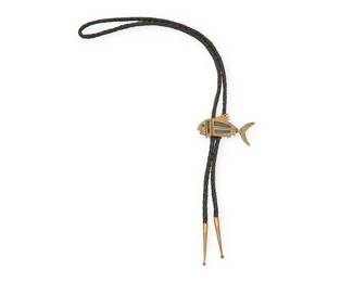 2182
A Mixed Metal Fish Bolo
Mid-20th century
Stamped verso: NA
With a central brass colored fish motif bolo slide with shadowbox details on a braided leather cord with brass cone tips
Bolo: 1.75" H x 2.875" W; Cord: 39" L
Estimate: $100 - $200