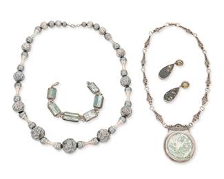 2187
A Group Of Studio Jewelry
Late 20th/21st century
One marked: Israel / 925; one marked: AKR / Sterling
Four works comprising an unmarked Roman glass pendant necklace and similar design bracelet, [likely Angie Olami], a silver and hematite bead brutalist-style necklace with textured silver beads, and a pair of sterling silver Amy Kahn Russell earrings with set pyrite in slate, 5 pieces
Necklaces: 26" L and 19" L; bracelet: 8" L; each earring: 1.125" H
256.3 grams gross
Estimate: $600 - $800