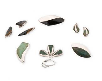 2171
A Group Of Enrique Ledesma Mexican Silver And Stone Inlay Jewelry
Enrique Ledesma (d. 1979)
Circa 1955-1979; Taxco, Mexico
Each variously stamped: Ledesma / Taxco / Hecho in Mexico / 925 / [Eagle 3] / [Eagle 60] / [design numbers: 214, 234, 235, 265, 266, 321]
Seven works in sterling silver comprising a floral brooch and three abstract brooches, each with greenstone or obsidian inlay, and a pair of similar design earrings, as well as an abstract silver and stone inlay tie pin together with a pair of matching cuff links, 9 pieces
Largest brooch: 1.125" H x 2.875" W; smallest: 1.125" H x 2.25" W; each earring: 1" H; tie pin: 0.5" H x 2" W; each cuff link: 0.625" H x 1.25" W
107.2 grams gross
Estimate: $400 - $600