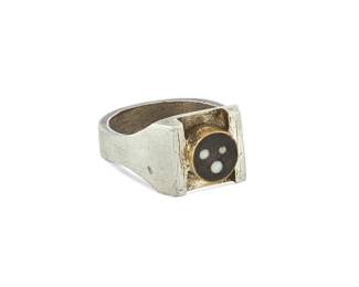 2035
A Peter Macchiarini Mixed-Metal Ring
Peter Macchiarini (1909-2001)
Circa 1960s, San Francisco, CA
Stamped: MACC
Designed with a set black stone with three inlaid white stone dots, set in a brass bezel on a sterling silver band with squared shoulders
Ring size: 7.75
9.9 grams gross
Estimate: $800 - $1,200