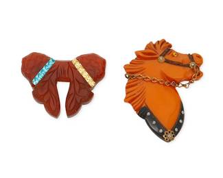 2178
Two Bakelite Brooches
Early/mid-20th century
Unmarked
Comprising an orange resin horse brooch with chain reins and carved and painted harness details, as well as an amber-colored carved resin bow brooch with carved feather and floral details and two rows of set rhinestones in blue and gold, 2 pieces
Larger: 3" H x 2.5" W; smaller: 1.875" H x 2.375" W
Estimate: $300 - $500