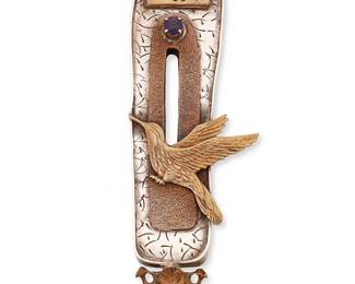 2042
A Susan Silver Brown "Bird Warrior Totem" Pendant/Brooch
Late 20th/21st century
Stamped verso: S.Silver Brown / Sterling / ©; further etched: 14K gold / artist's proof
An intricate sterling silver and 14K gold mixed metal brooch with applied bird motif and set purple gemstone
4.75" H x 1.625" W
57.4 grams gross
Estimate: $200 - $400