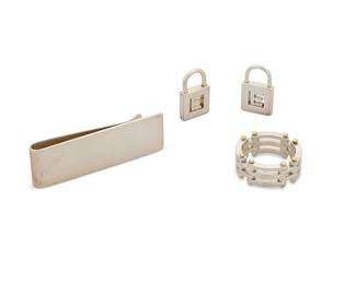 2003
A Group Of Tiffany & Co. Sterling Silver Jewelry
Late 20th/21st century
Each variously stamped: © / Tiffany & Co. / 925 / 750 / T & Co.
A group of various jewelry items including a sterling silver money clip, a sterling silver and 14K gold mesh link ring, and two small lock motif pendants, with E letters, 4 pieces
Clip: 0.75" H x 2.25" W; ring: size 11.25; pendants: 0.875" H x 0.5" W
44.9 grams gross
Estimate: $500 - $700