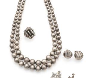 2089
A Group Of William Spratling Silver Jewelry
William Spratling (1900-1967)
Circa 1940-1944 and 1964-1967; First and Third Design Periods; Taxco, Mexico
Each stamped for William Spratling; further variously stamped: Silver / Made in Mexico / [Indistinct eagle] / 925
Comprising a double-strand bead necklace, a pair of hand-form screw-back earrings, a pair of bow screw-back earrings, and a ring, 6 pieces
Necklace: 16.25" L; Each earring: 0.75" H; Ring: size 6
96.7 grams gross
Estimate: $600 - $800