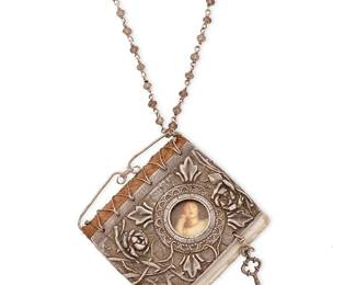 2054
A Christi Anderson Elemental Adornments Book Necklace
21st century
Marked with artist and title to paper tag; further marked: .999
A fanciful silver "Sleeping Beauty" motif book pendant necklace suspended from a fine silver chain with various gemstone and freshwater pearl beads, the toggle square marked: "of one for another"
28" L x 2.25" H x 2.5" W
55.2 grams gross
Estimate: $400 - $600