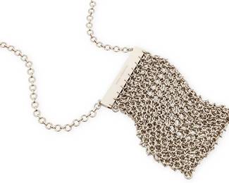 2099
A Vintage Paco Rabanne Chain Mail Purse/Necklace
Late 20th century
Marked to frame exterior: Paco Rabanne
A chunky silver-toned metal chain mail shoulder bag or necklace with a magnetic frame clasp and single chain mail strap
6.25" H x 3.5" W; strap drop: 21.5"
Estimate: $200 - $300