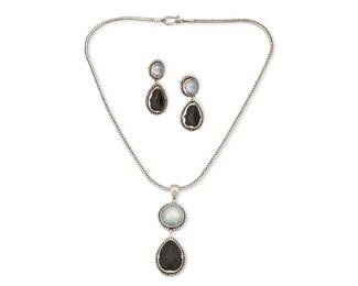 2088
A Set Of Janice Girardi Designs Jewelry
Late 20th/21st century
Pendant stamped: JGD / © / 925
A grey mabe pearl and cut black stone pendant on a silver snake chain, together with a matching pair of earrings, 3 pieces
Necklace: 2.5" H x 17" L; Each earring: 1.625" H
41.8 grams gross
Estimate: $400 - $600