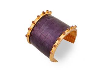 2123
A Kara Ross Cuff Bracelet
Late 20th/21st century
Stamped for maker
A chunky gold-plated cuff with purple crocodile-stamped leather and fourteen set amethyst cabochons
6.5" inner C x 2.125" H
137.0 grams gross.
Estimate: $150 - $250